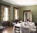 A view of the dining room at Elizabeth Farm looking north-east towards the entry hall and veranda. The room, part of the original 1793 cottage, was greatly modifed in the late 1820s and early 1830s. The table is set for breakfast using collection items from Elizabeth Bay House approporiate for Elizabeth Farm (the setting was created for this image and is not part of the usual house interpretation). The setting itself is based on a c1823 watercolour by Mary Ellen Best.