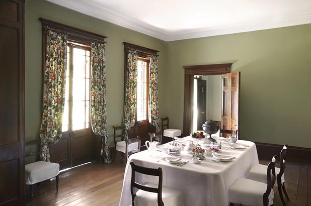 A view of the dining room at Elizabeth Farm looking north-east towards the entry hall and veranda. The room, part of the original 1793 cottage, was greatly modifed in the late 1820s and early 1830s. The table is set for breakfast using collection items from Elizabeth Bay House approporiate for Elizabeth Farm (the setting was created for this image and is not part of the usual house interpretation). The setting itself is based on a c1823 watercolour by Mary Ellen Best.