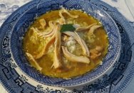 Mulligatawny soup and rice in a blue and white bowl.