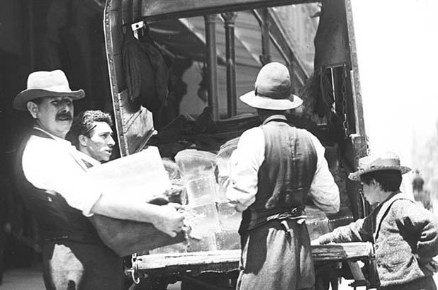 Detail of a photograph showing blocks of ice being delivered.