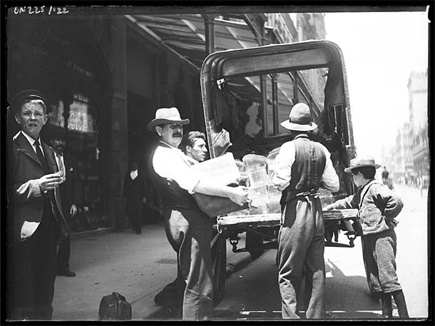 Blocks of ice being delivered, on the street.