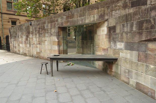 The Irish Famine Memorial, showing names, table, stool and empty plate.