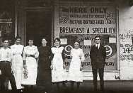 Close up detail of Emmanuel (far right) and staff standing outside his restaurant, c1920s.