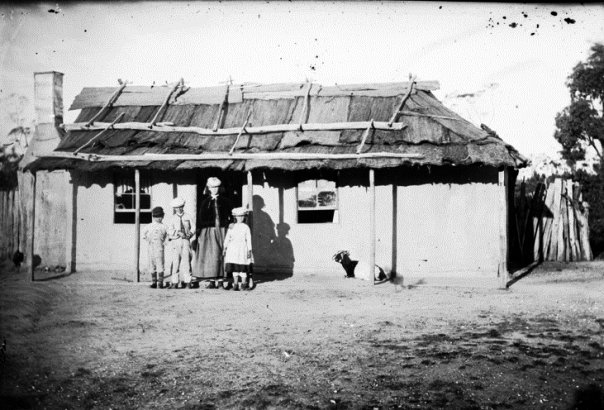 Children in front of whitewashed house with bark roof Hill End, American & Australasian Photographic Company, 1870-1875