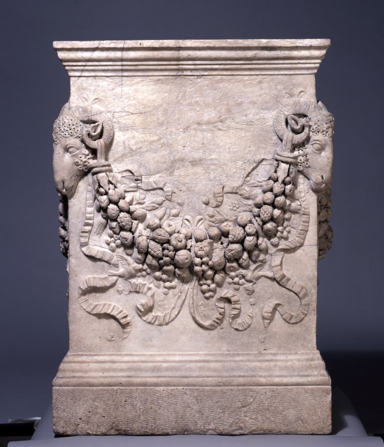 Roman altar, on each side a floral festoon pendent from ram's head on the edges.